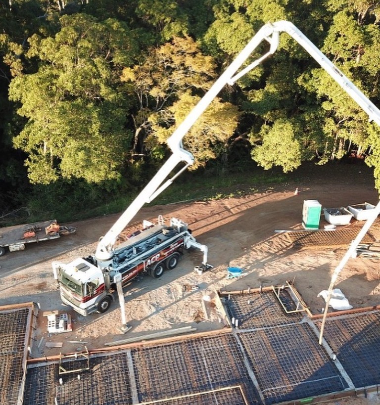 Before — site prep with pump truck and steel reinforcement
